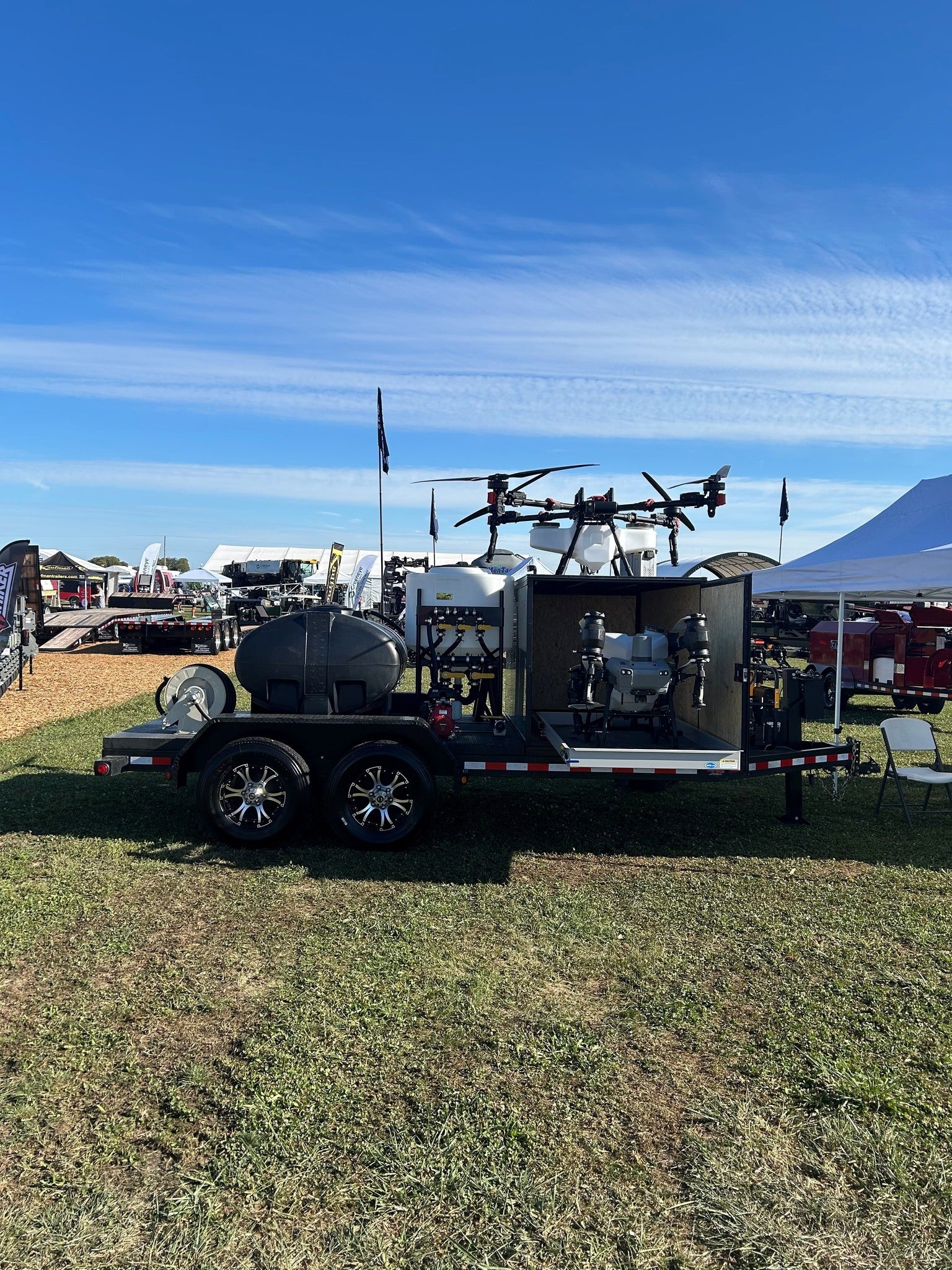 Trailer with equipment on a grassy area under a clear blue sky