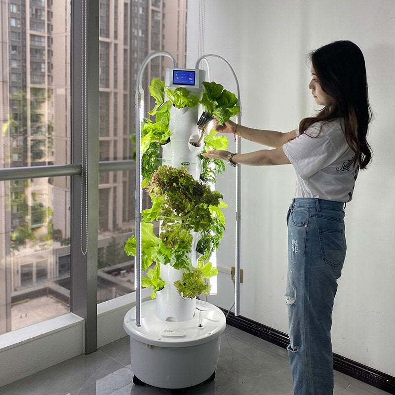 women planting in a hydroponics tower.