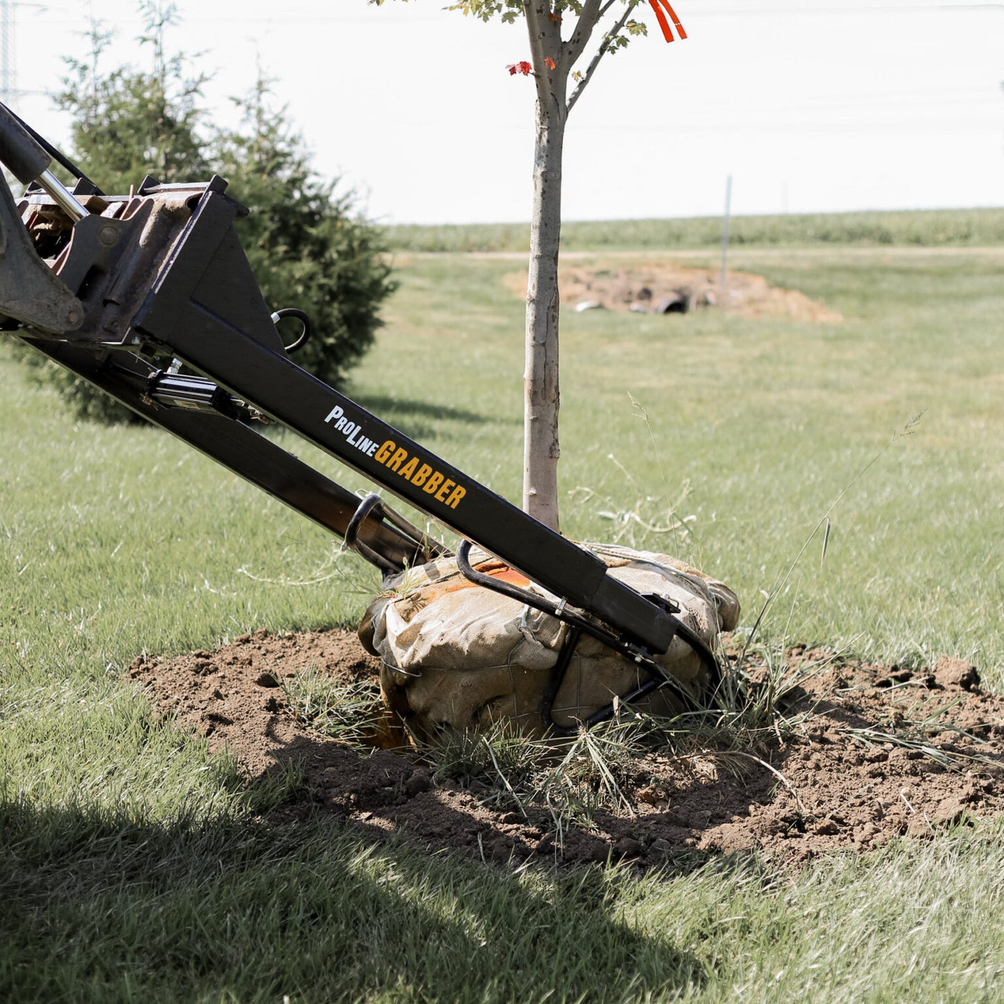 ProLine Tree Planting Equipment | Model Grabber XL | Width 54" | Rootball Capacity 32"-54" | Reach 8' | Hydraulic Flow Range 15–25 GPM | For Skid Steers