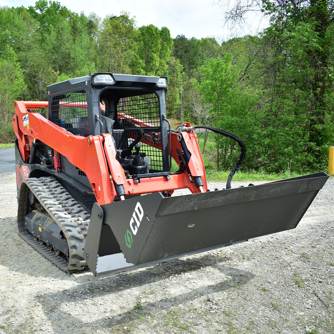 4-in-1 bucket mounted on a compact track loader with the bucket jaw fully open